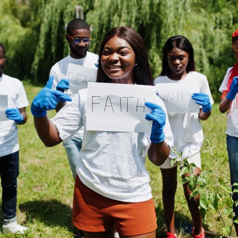 group-happy-african-volunteers-hold-blank-board-with-faith-sign-park-africa-volunteering-charity-people-ecology-concept_627829-322