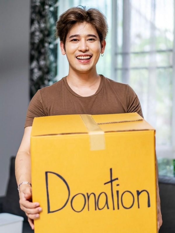 happy-volunteer-asian-man-holding-a-donate-box-for-giving-smiling-male-working-at-charity-center-.jpg